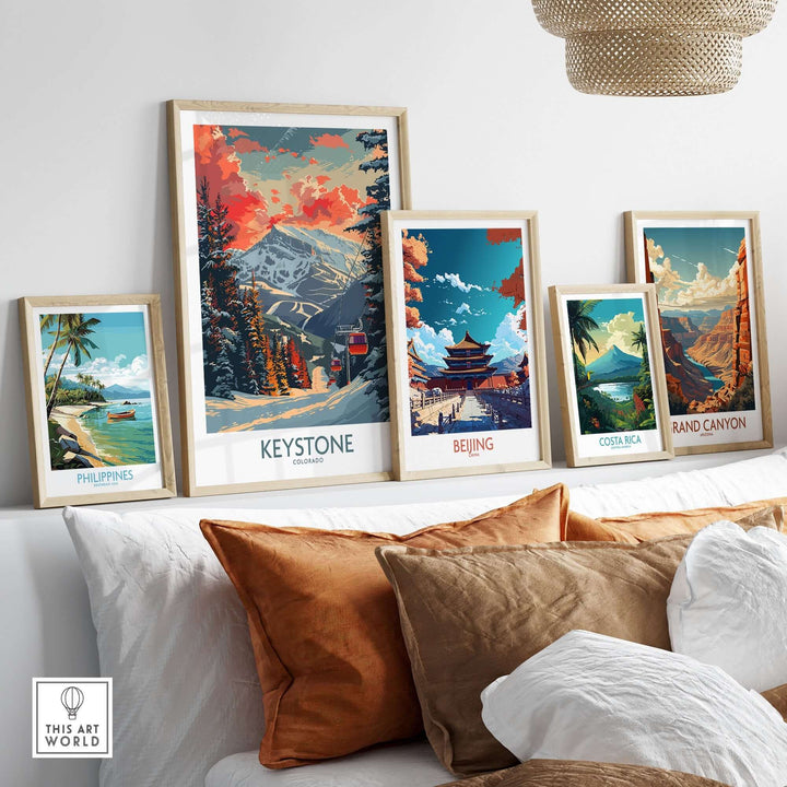 Collection of travel posters on a wall, featuring Keystone Colorado, Beijing, Costa Rica, Grand Canyon, and Philippines.