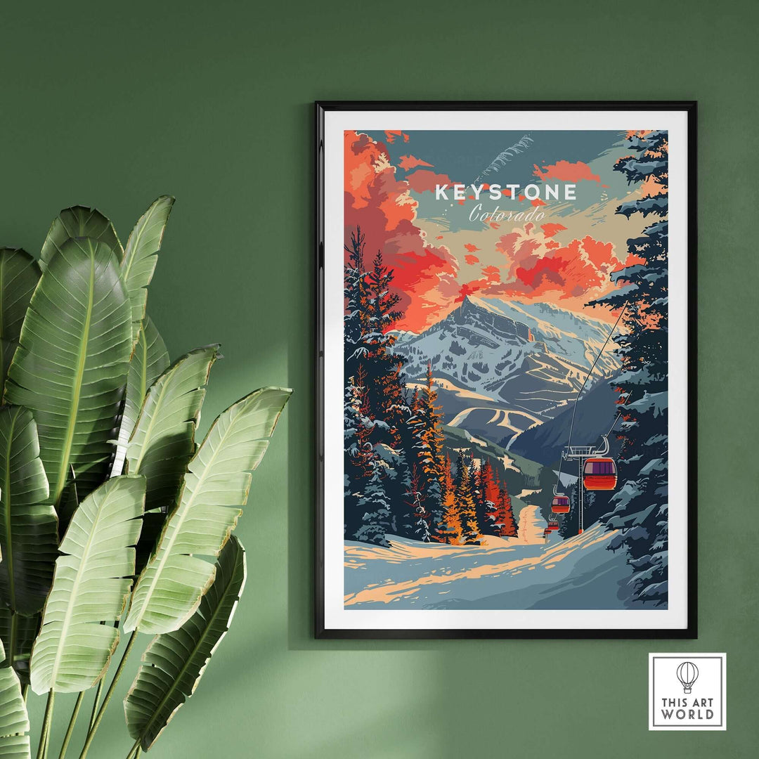 Keystone Colorado print with snowy mountain landscape and ski lift, framed art on green wall with tropical plant.