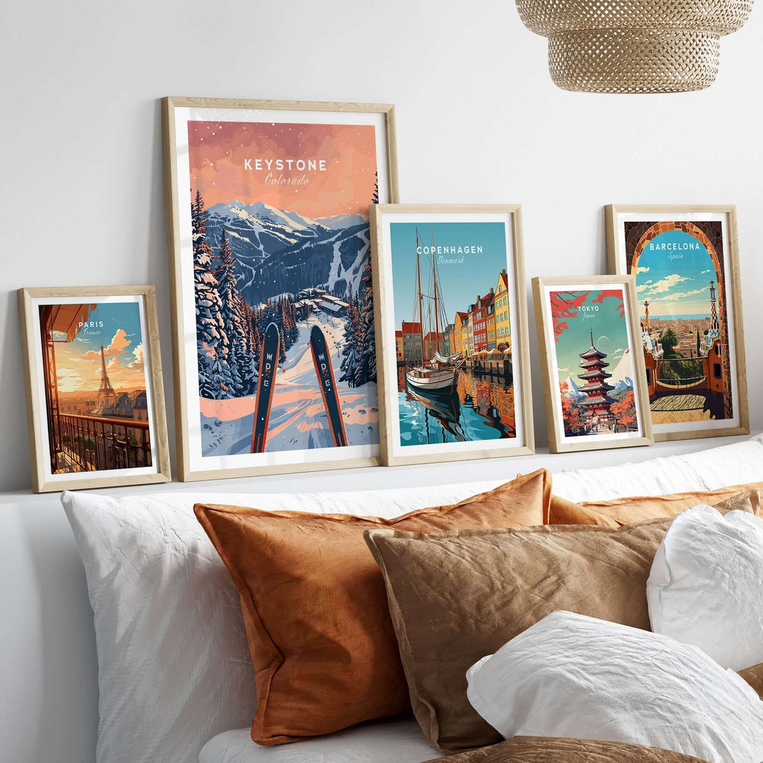 Keystone Colorado ski poster displayed among travel-themed posters on a cozy living room shelf.