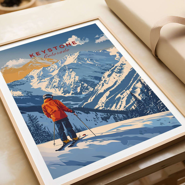 Keystone Travel Poster showcasing a skier in vibrant orange jacket against Colorado mountain scenery. Perfect for ski enthusiasts.