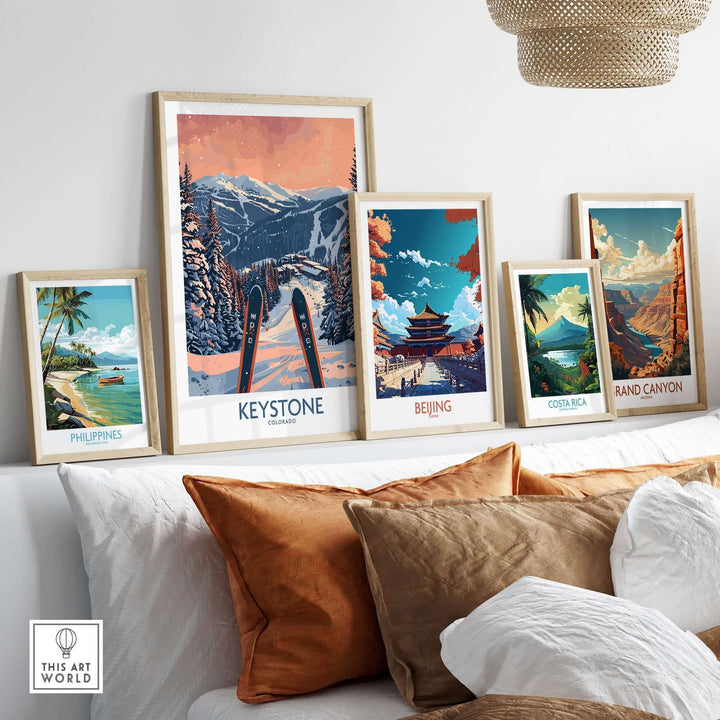 Collection of framed travel posters including Keystone Colorado ski art displayed on a modern shelf