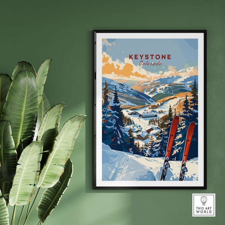 Keystone Colorado ski art print with snowy mountain scene, red skis, and evergreen trees, displayed on a green wall.