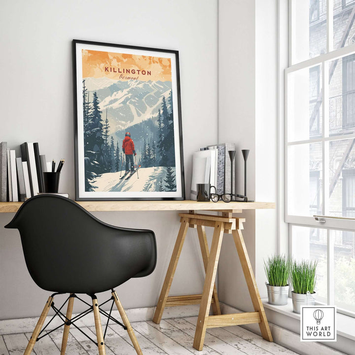 Stylish room with framed Killington Vermont print showcasing winter landscape on a desk, modern chair, and large window view.