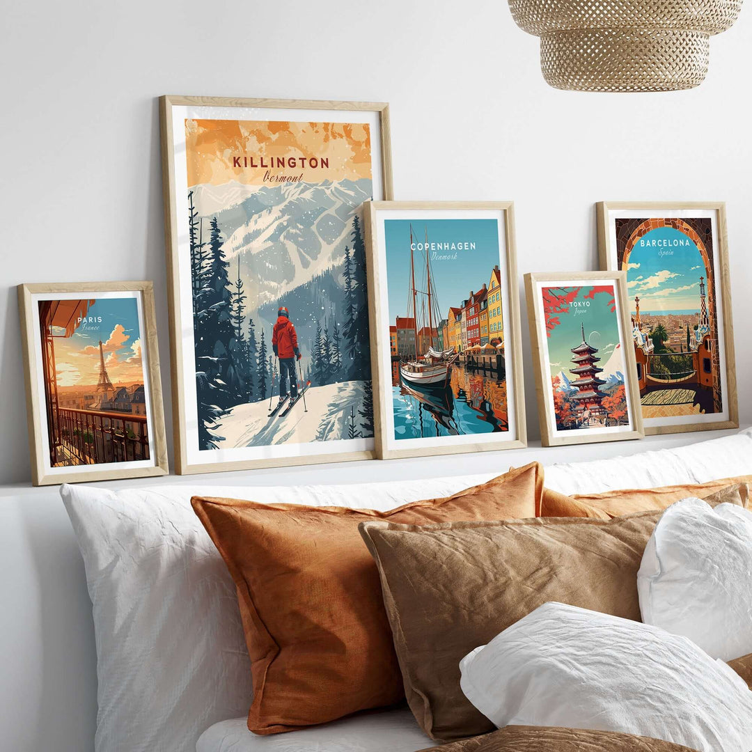 Gallery wall with framed prints, including Killington Vermont, displayed above a cozy bed with decorative pillows.