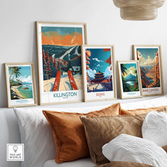 A stylish display of framed travel art prints, including Killington, Beijing, Costa Rica, and the Grand Canyon, in a cozy setting.