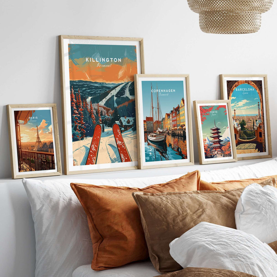 Killington travel poster framed among other travel posters on a cozy sofa with decorative pillows.