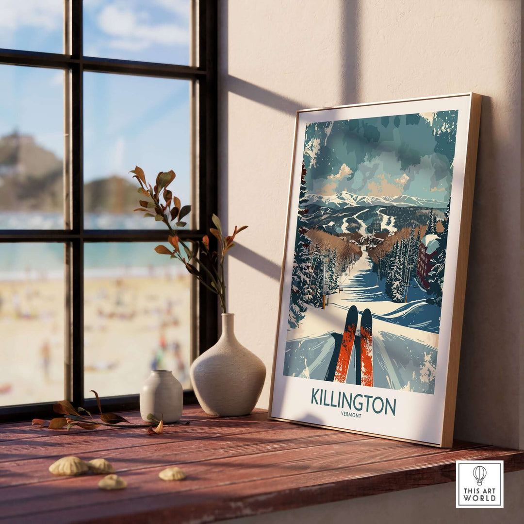 Killington wall art poster displayed on a windowsill with beach view, featuring winter ski landscape and blue skies.