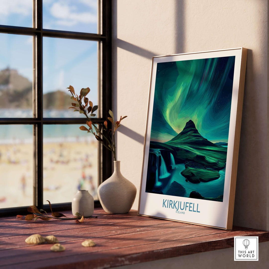 Kirkjufell Iceland Art Print | Waterfall Poster displayed on a wooden table near a window.