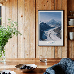 Kluane National Park Wall Art Canvas Print featuring dramatic mountain scenery and a winding river in a cozy home setting.
