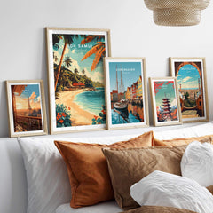 Koh Samui Wall Art collection featuring tropical landscapes and cityscapes in stylish frames on a cozy couch.
