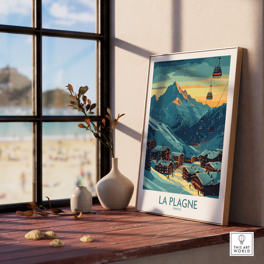 La Plagne France ski poster displayed on a windowsill with mountain scenery and chairlifts, enhancing a cozy home decor setting.