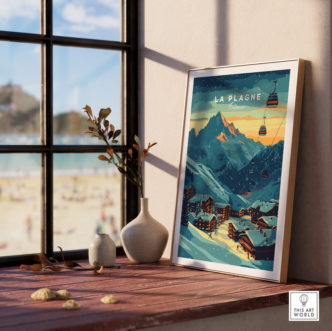 Framed La Plagne Print France Ski Poster on windowsill with mountain scene and cabins, sunlight streaming through window.