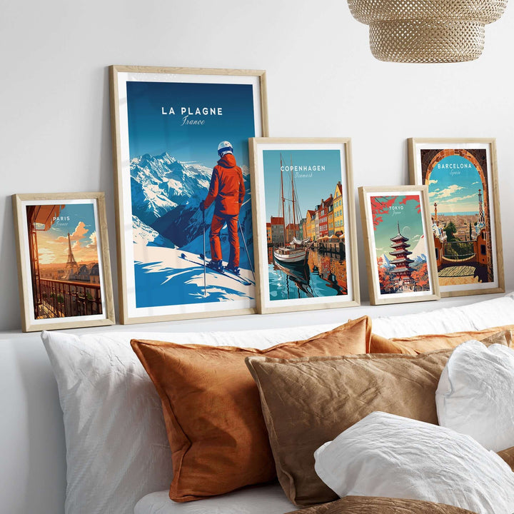 La Plagne travel poster among framed art prints, showcasing winter scenery and vibrant colors in a cozy room setting.