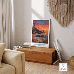 Laguna Beach California Sunset Art Print | Vibrant Coastal Poster displayed in a stylish living room setting.