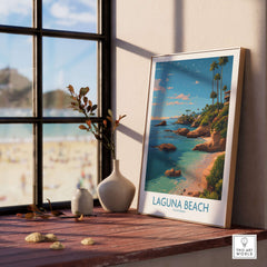 Laguna Beach California Coastal Cliff Art Print | Palm Tree Seascape Poster displayed on a wooden table by a sunny window.