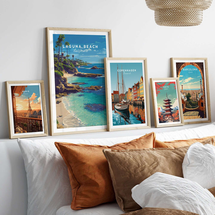 Laguna Beach Print | Southern California Wall Art displayed among other framed artworks on a cozy bed with decorative pillows.