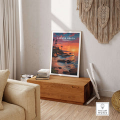 Laguna Beach Pacific Ocean Print displayed in a cozy living room, showcasing a serene sunset over the ocean.