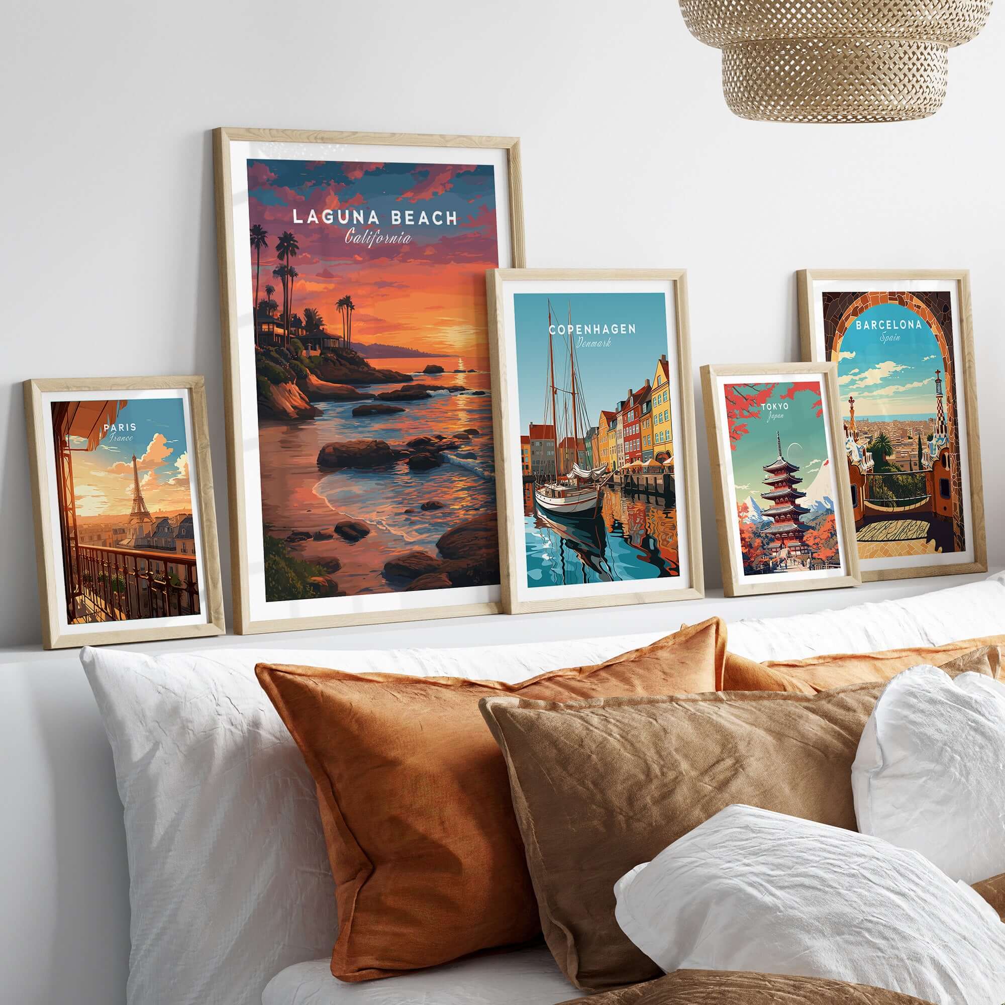 Laguna Beach Pacific Ocean Print framed among other travel posters in a stylish home decor setting.