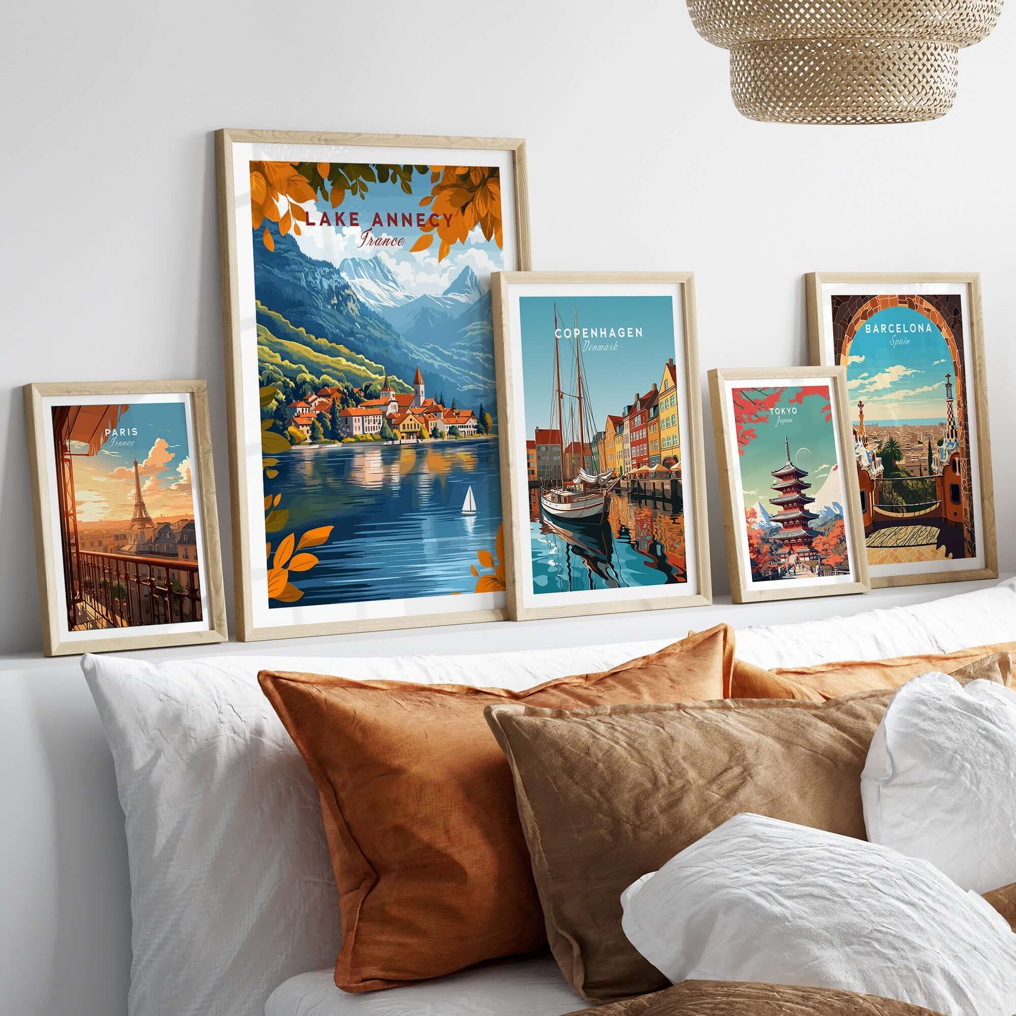 Lake Annecy Travel Print France displayed among various travel prints in a cozy home setting, showcasing vibrant designs.