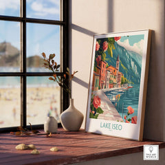 Lake Iseo Art Print Italy displayed on a wooden shelf with a sunny view outside, showcasing vibrant colors and scenic beauty.