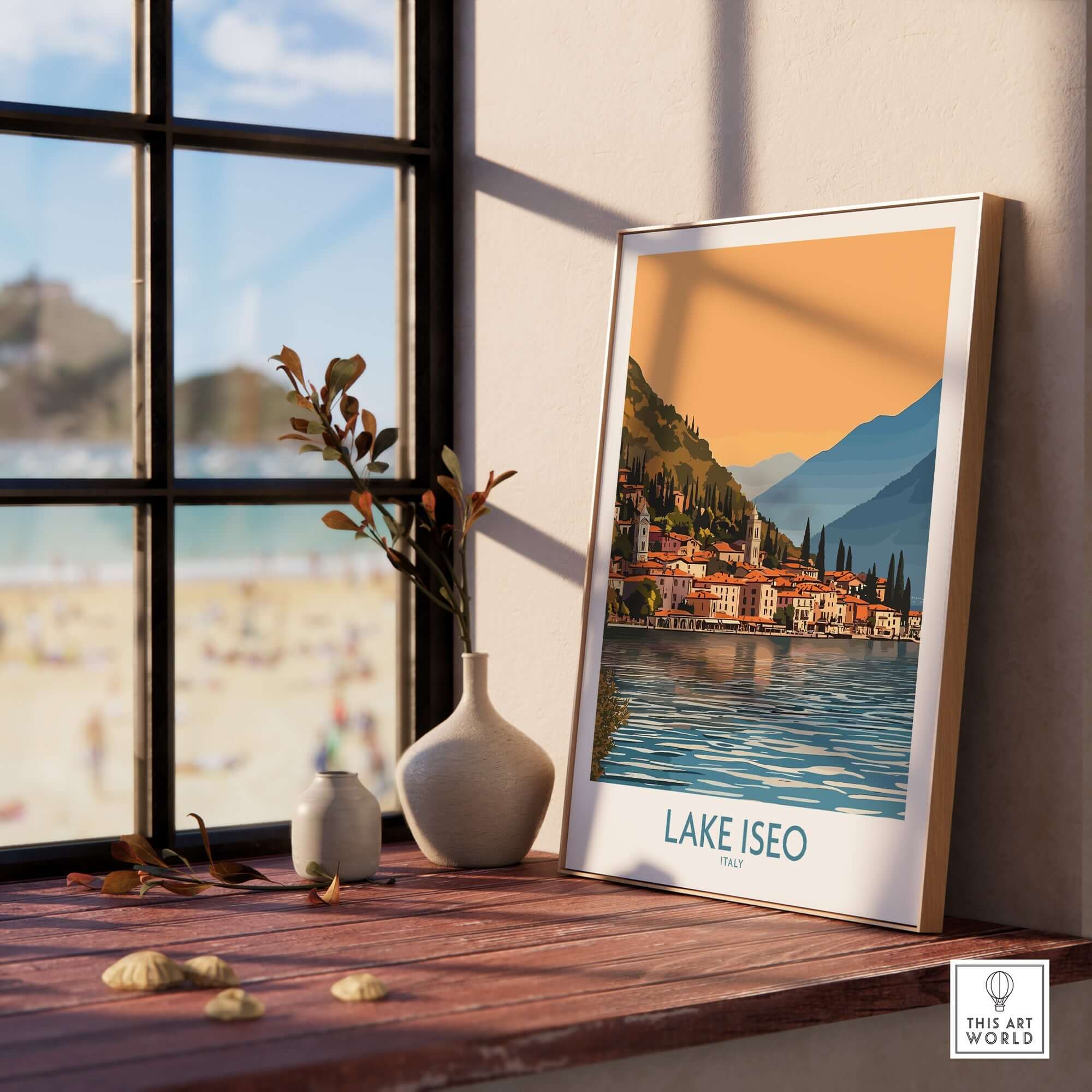 Lake Iseo Poster Italy displayed on a wooden table by a window, showcasing the stunning scenery of Italy's Lake Iseo.