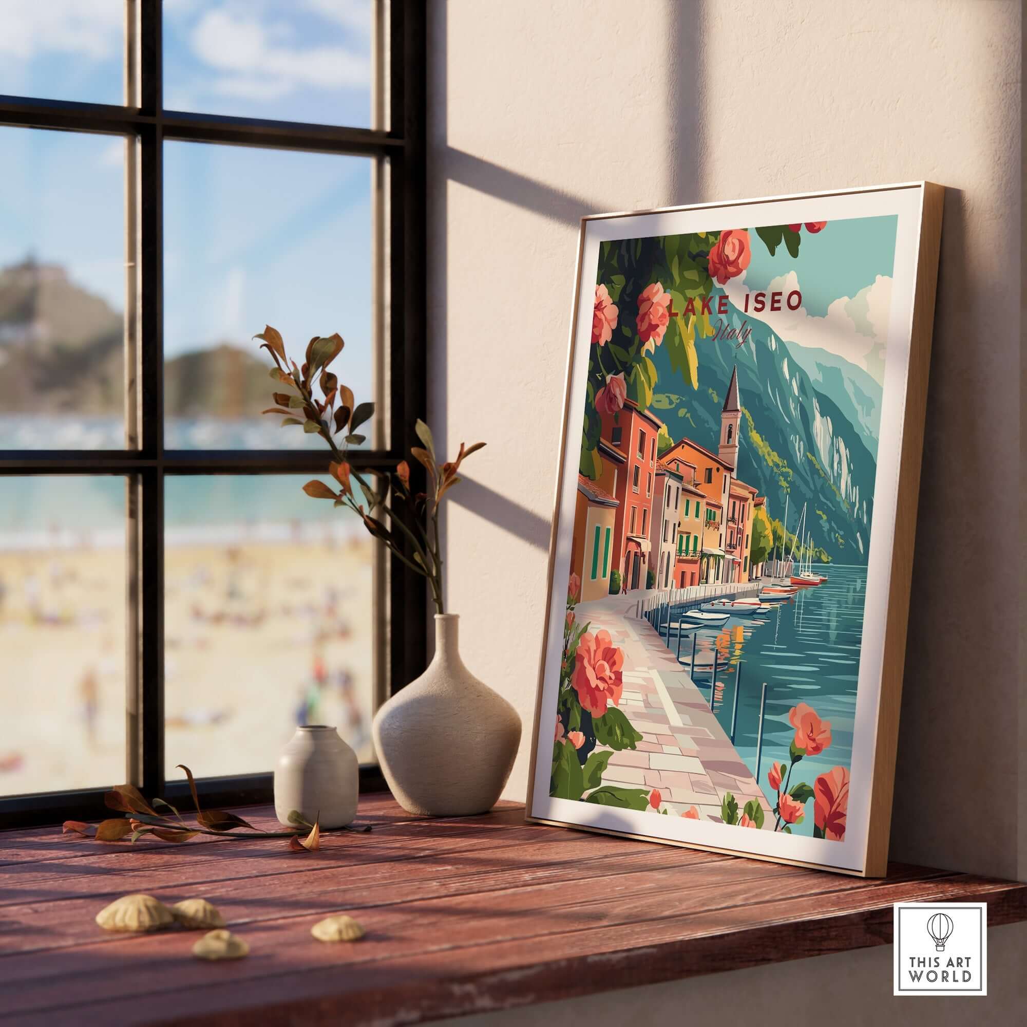Lake Iseo Wall Art Poster displayed on a wooden table near a window, showcasing serene lake scenery and vibrant flowers.