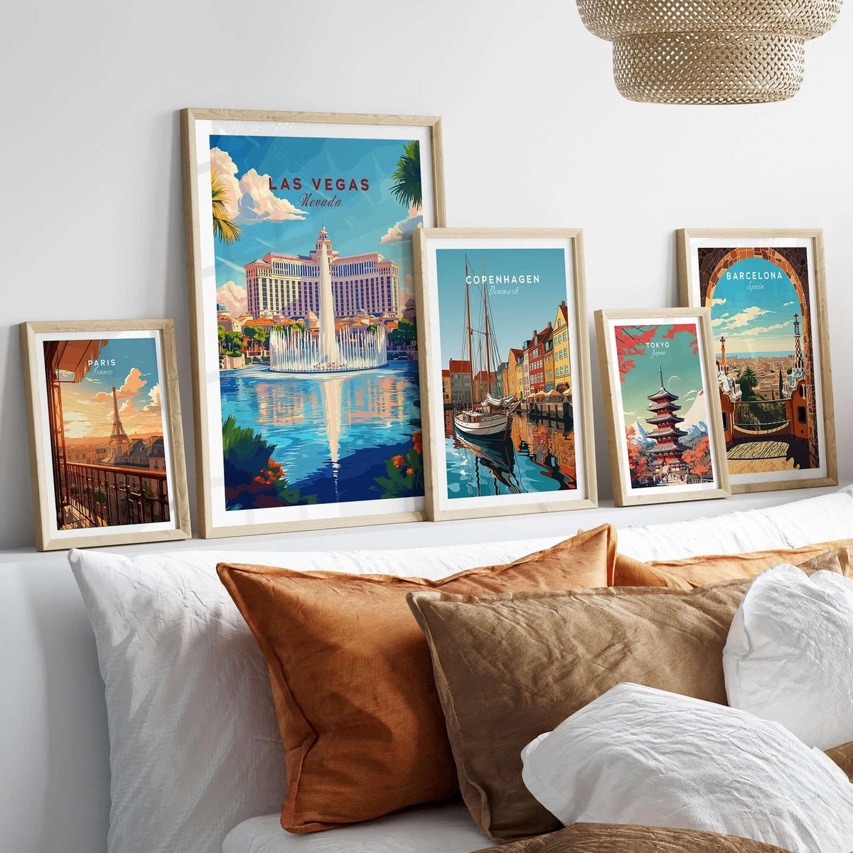 Las Vegas Travel Print collection of framed travel art prints on a stylish bed, showcasing vibrant cityscapes.