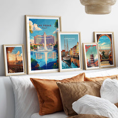 Las Vegas Travel Print collection of framed travel art prints on a stylish bed, showcasing vibrant cityscapes.