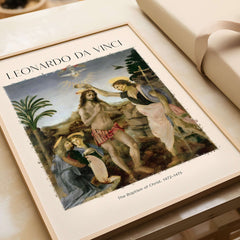 Leonardo da Vinci Art Print The Baptism of Christ 1470s displayed in a wooden frame with a light background.