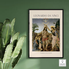 Leonardo da Vinci Art Print The Baptism of Christ 1470s displayed on a green wall with plants.
