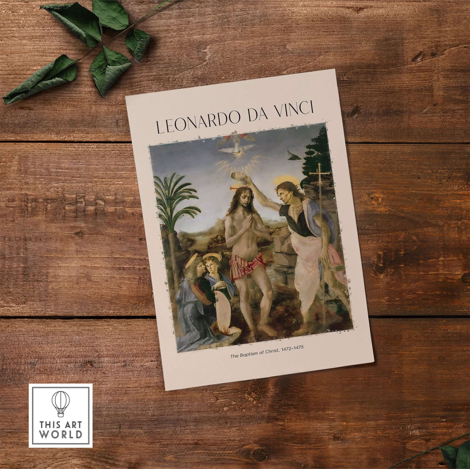 Leonardo da Vinci Art Print The Baptism of Christ 1470s on a wooden surface with green leaves.