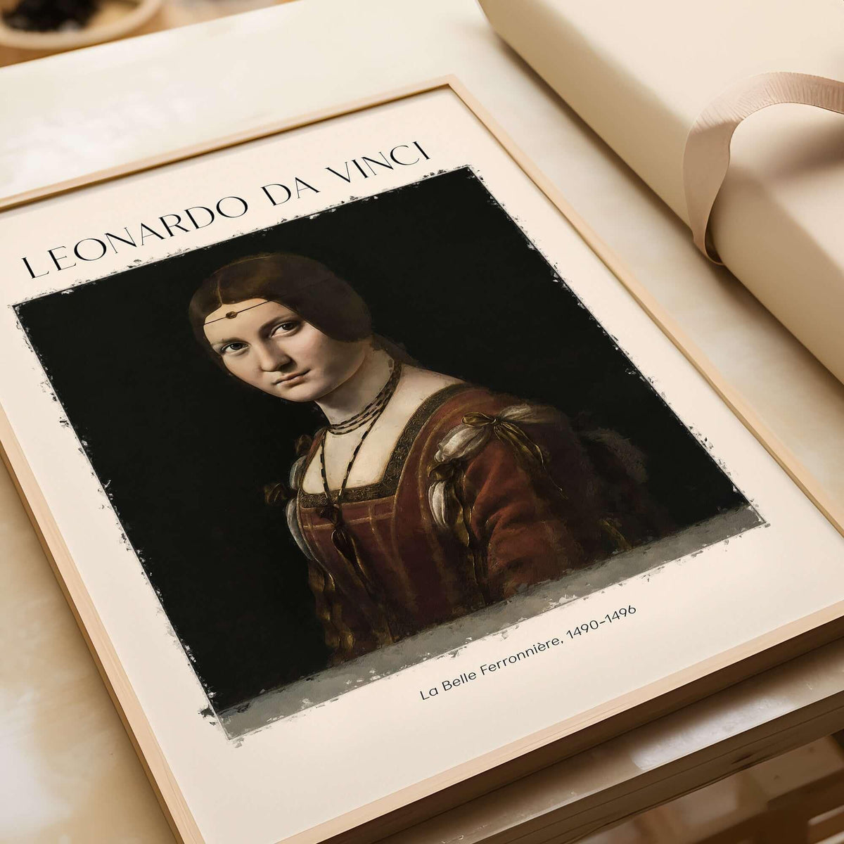 Leonardo da Vinci La Belle Ferronnière 1490s Renaissance Portrait Art Print displayed in a frame on a table.