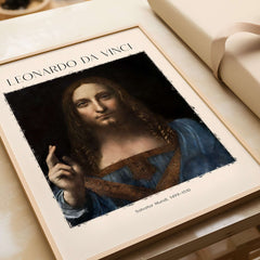 Leonardo da Vinci Salvator Mundi c1500 Portrait of Christ Art Print Poster displayed on a table with a gift box.