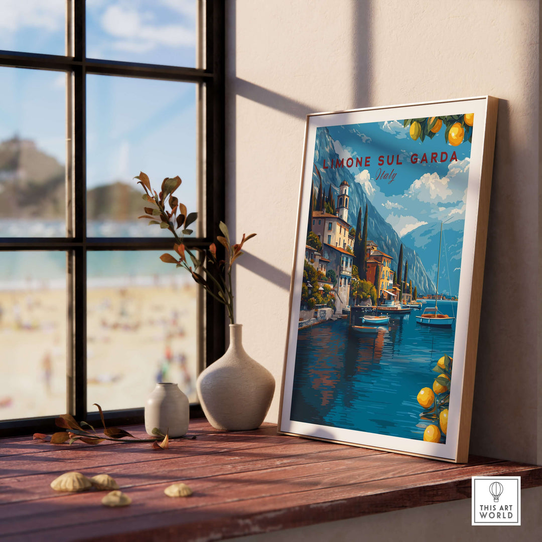 Limone sul Garda Poster - Italy Lake Garda Wall Art displayed on a table by a sunlit window with beach view.