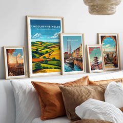 Lincolnshire Wolds Wall Art Print displayed among other framed travel art prints on a cozy bed.