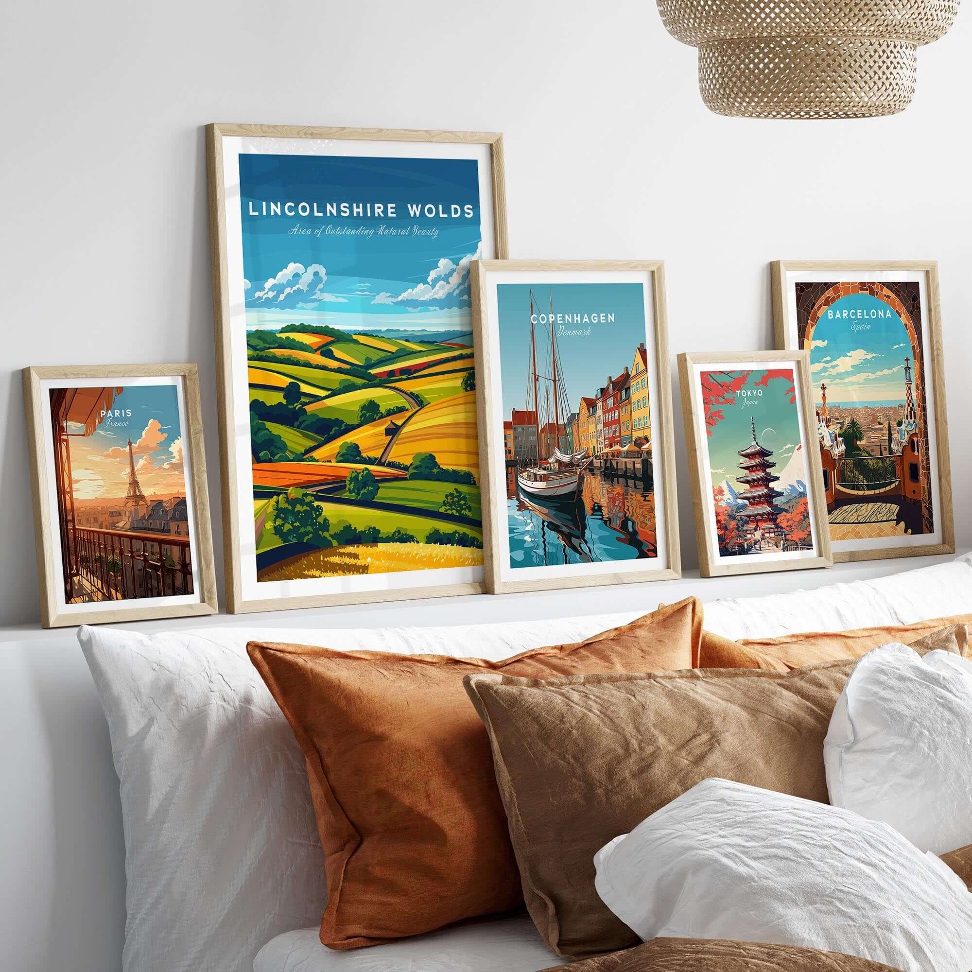 Lincolnshire Wolds Wall Art Print displayed among other framed travel art prints on a cozy bed.