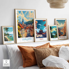 Ljubljana Travel Poster displayed among travel art prints on a stylish shelf with decorative pillows.