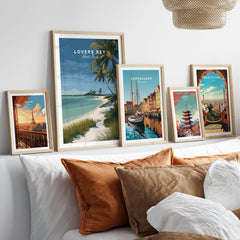 Lovers Key Florida Travel Poster | Coastal Path & Dunes Wall Art Print displayed with other travel posters on a cozy sofa.