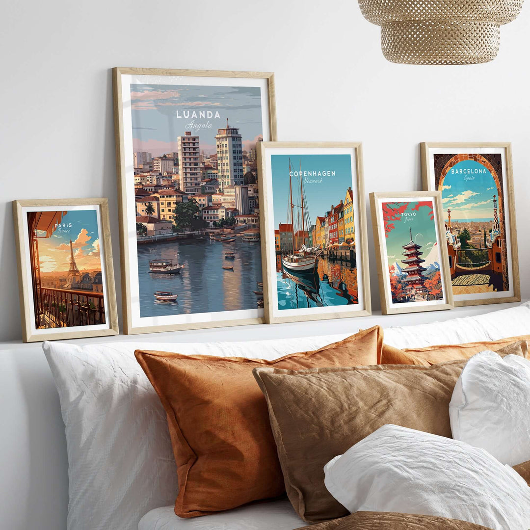 Framed Luanda art print and cityscape posters on a decorative wall above a cozy sofa.