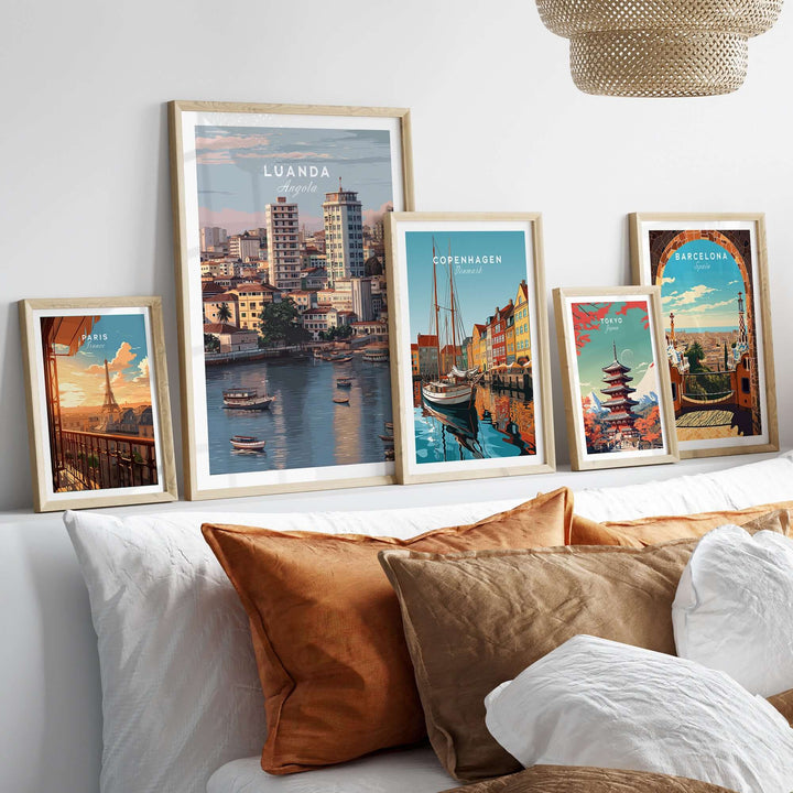 Framed Luanda art print and cityscape posters on a decorative wall above a cozy sofa.