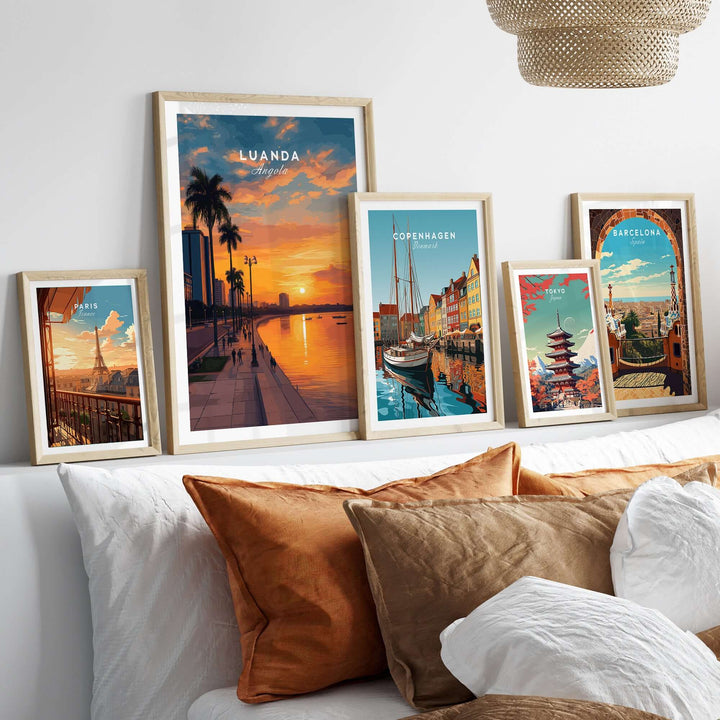 Framed urban posters showcasing Luanda at dusk and other cityscapes on a stylish sofa.