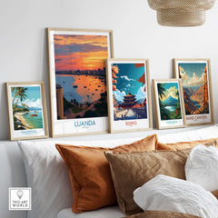 Luanda Poster - Angola Bay Cityscape Sunset Art Print - City Wall Decor displayed among other travel art prints on a stylish sofa.