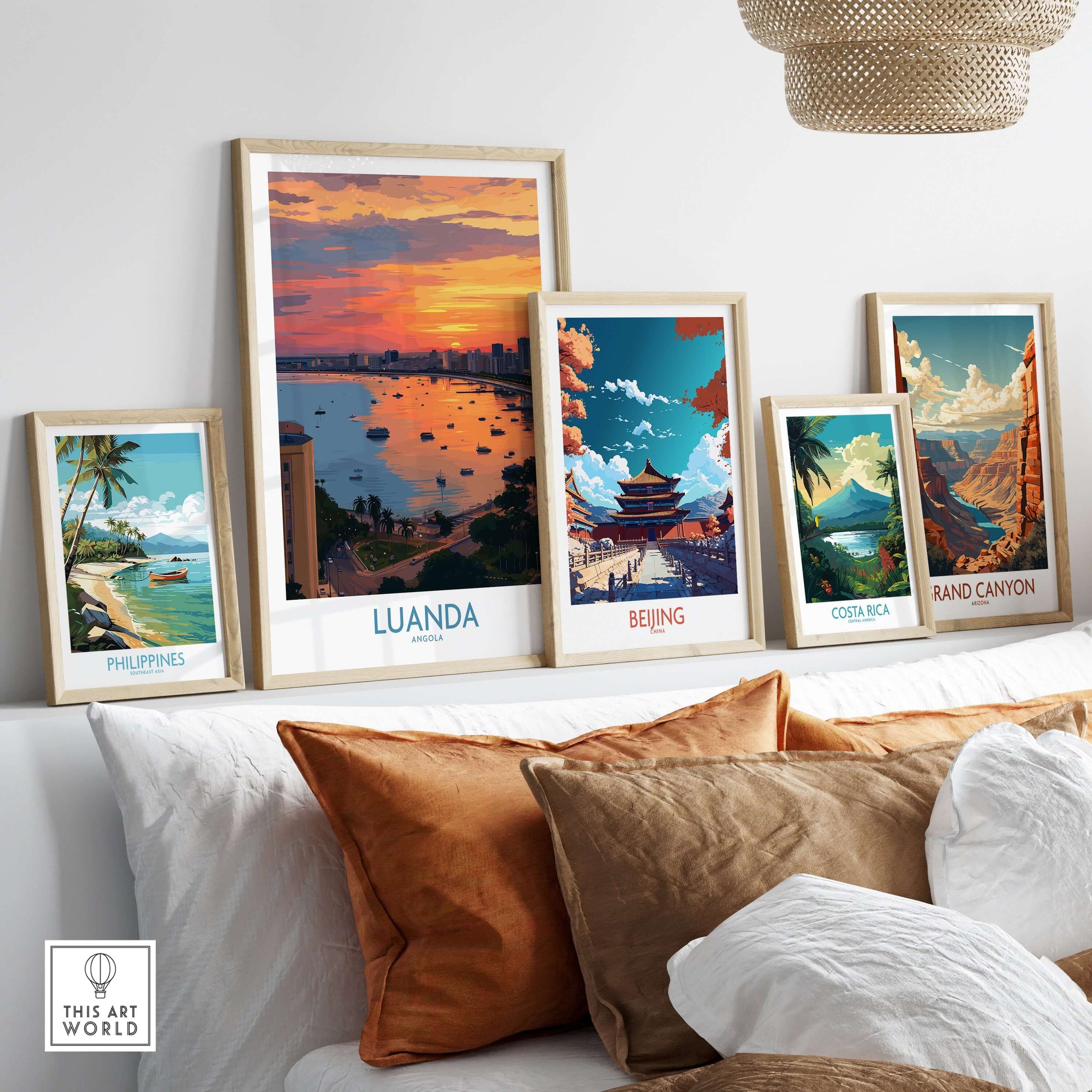 Luanda Poster - Angola Bay Cityscape Sunset Art Print - City Wall Decor displayed among other travel art prints on a stylish sofa.