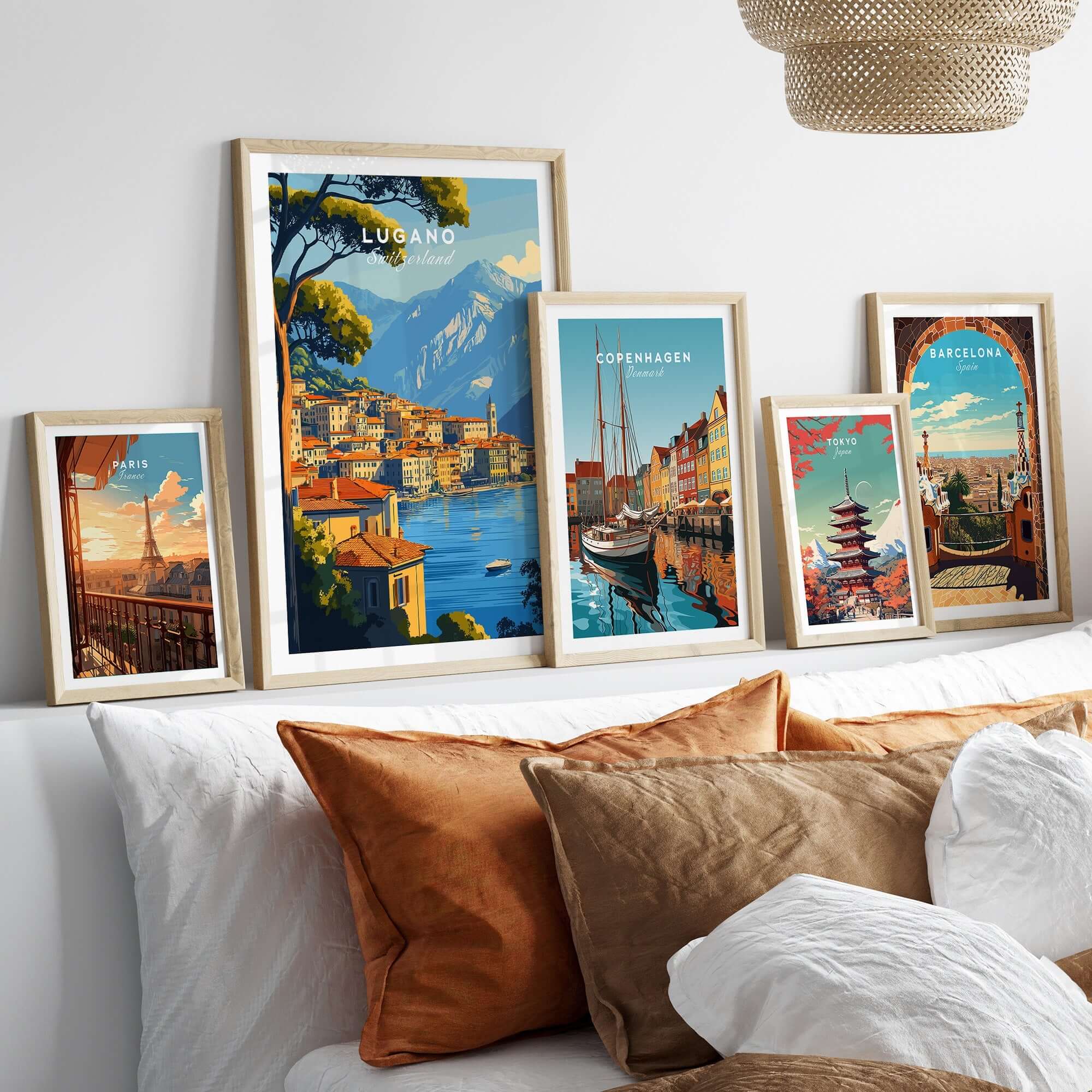 Lugano Travel Print displayed among other travel posters in a stylish home decor setting.