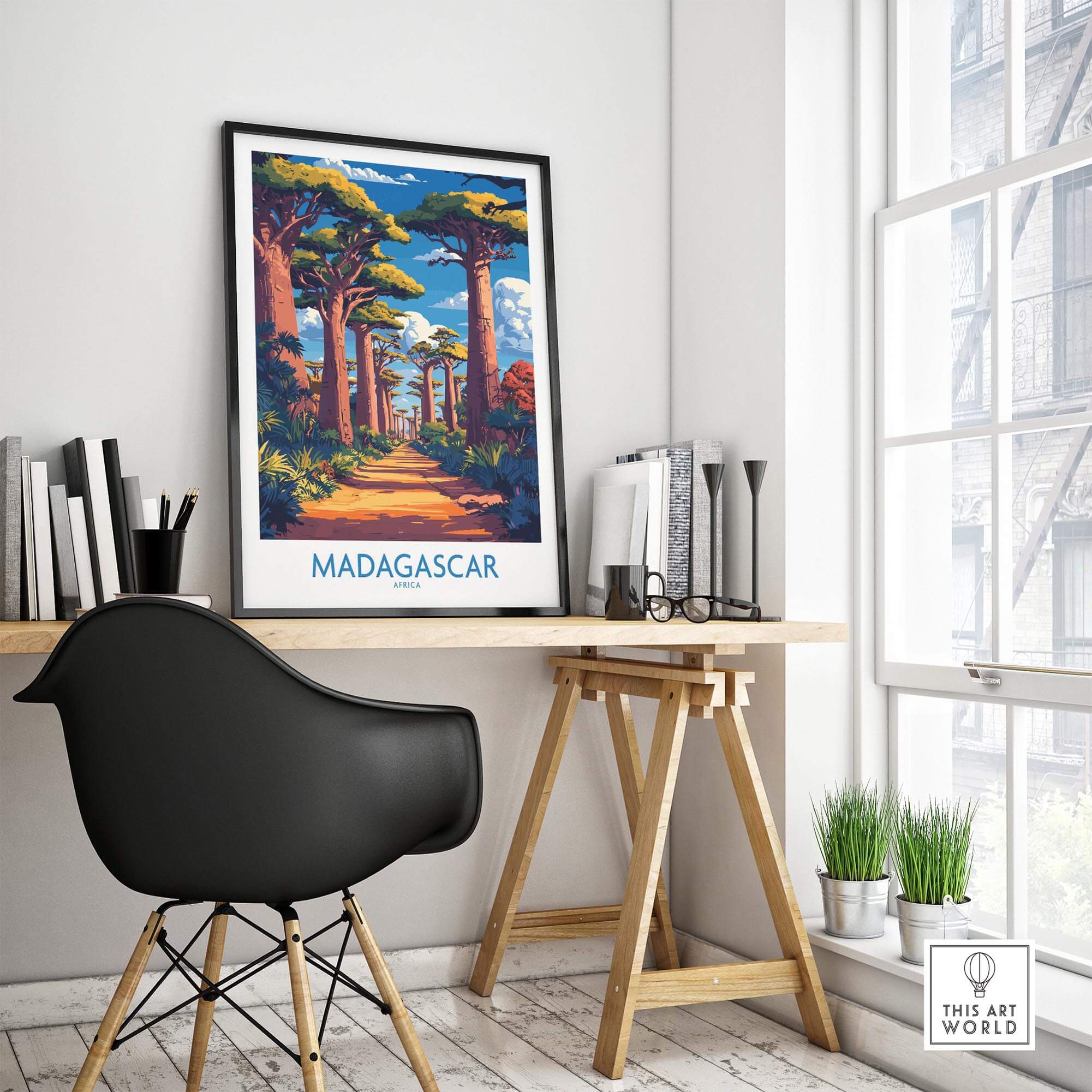 Madagascar Wall Art Print framed on a desk in a stylish room, showcasing the vibrant Avenue of Baobabs.