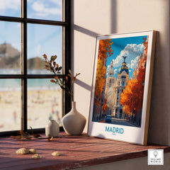 Madrid Wall Art Print displayed on a wooden table beside a window, featuring autumn colors and a vibrant cityscape.