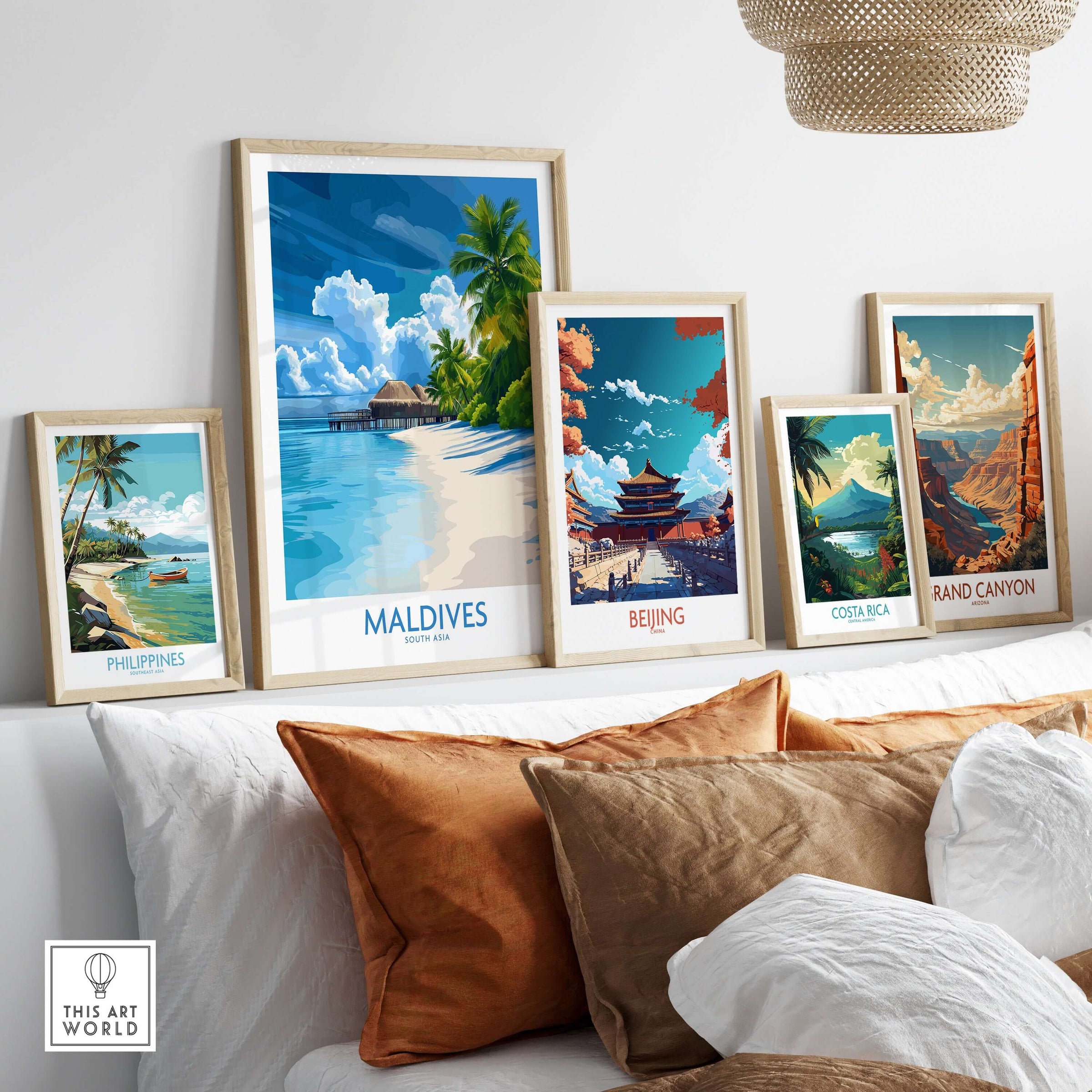 Maldives Wall Art Print - Tropical Beach showcased among other travel-themed prints on a stylish sofa.