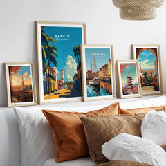 Maputo Travel Print Mozambique displayed among other travel posters on a stylish bed with decorative pillows.