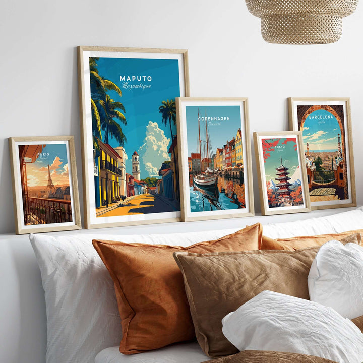 Maputo travel print and other city posters displayed on a wall above a bed with decorative pillows.