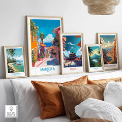 Marbella Spain Wall Art Print displayed among other travel art prints on a stylish shelf, showcasing vibrant colors and landscapes.